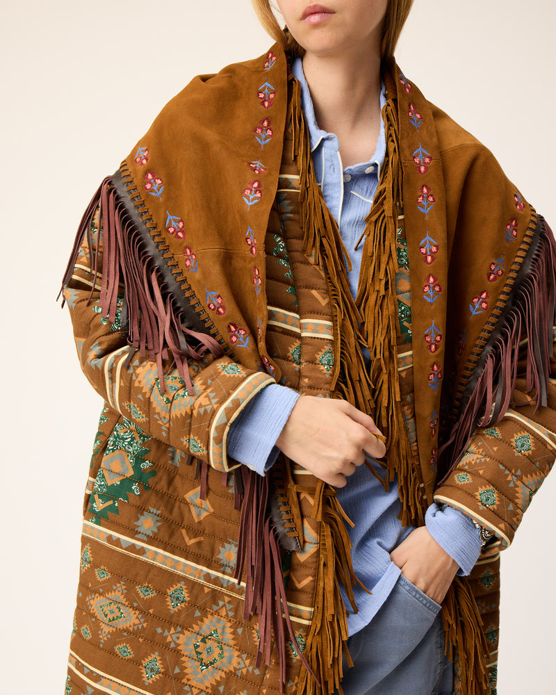 Large suede leather scarf with brown fringes on top of a coat